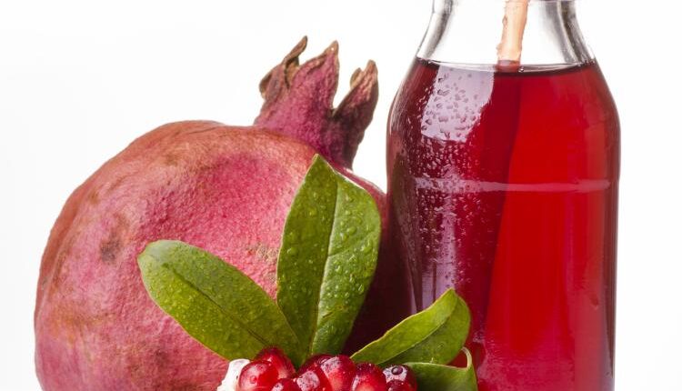 عکس استوک انار و آب انار – Grapefruit Fresh Juice Stock Photo